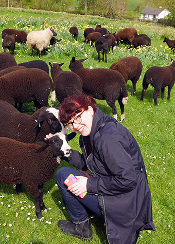 Libby petting the Zwartbles sheep
